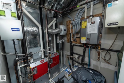 The property includes a water heater, heating and cooling systems, and various utility connections - 20650 94A Avenue, Edmonton, AB - Indoor Photo Showing Basement