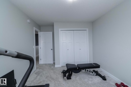 This room features light grey walls, light grey carpet, a white ceiling, and white trim - 20650 94A Avenue, Edmonton, AB - Indoor Photo Showing Bedroom