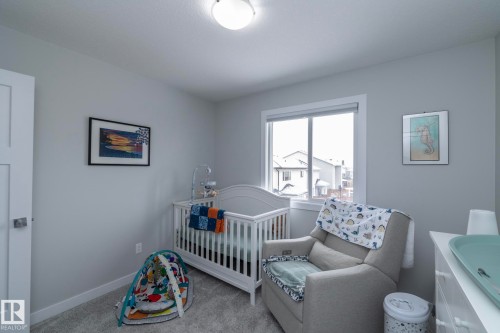 This room features light grey walls, grey carpet, and a window providing natural light - 20650 94A Avenue, Edmonton, AB - Indoor Photo Showing Bedroom