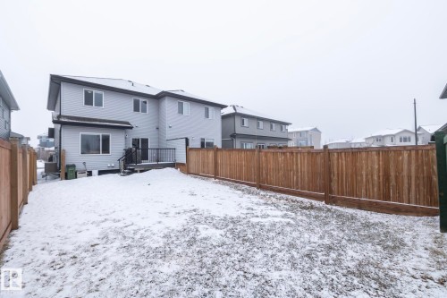The property features a private yard with a wooden fence and a multi-level deck - 20650 94A Avenue, Edmonton, AB - Outdoor With Exterior