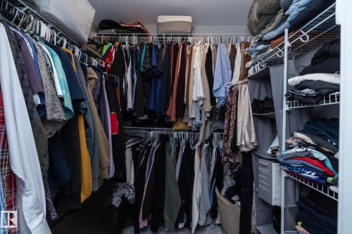 The property features a walk-in closet with wire shelving and hanging rods providing storage solutions - 20650 94A Avenue, Edmonton, AB - Indoor With Storage