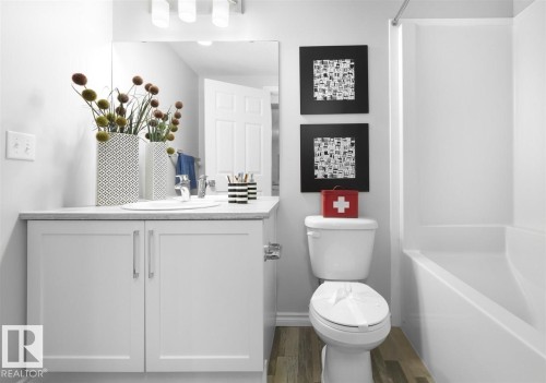 The bathroom features a white vanity with two cabinet doors, a rectangular sink, and a light-colored countertop - 20650 94A Avenue, Edmonton, AB - Indoor Photo Showing Bathroom