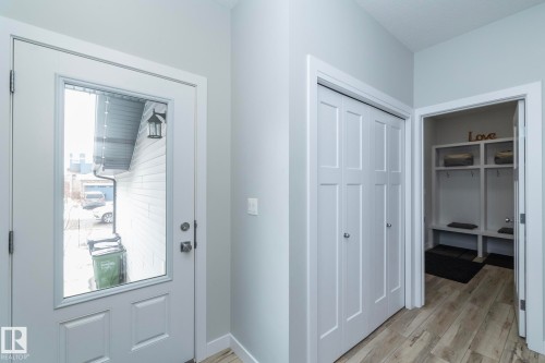 Entryway featuring a white door with a window, light-colored walls, and wood-look flooring - 20650 94A Avenue, Edmonton, AB - Indoor Photo Showing Other Room