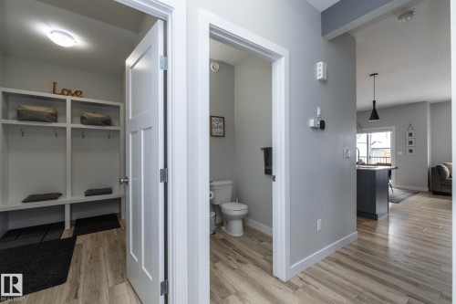 This entryway features light wood-look flooring and a built-in storage unit with hooks and shelving - 20650 94A Avenue, Edmonton, AB - Indoor