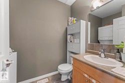 The property features a bathroom with a vanity, an integrated sink, a faucet, and a mirror - 