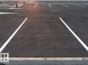 Paved parking area featuring white parking space lines and a concrete parking curb - 9363 Simpson Drive Nw, Edmonton, AB 