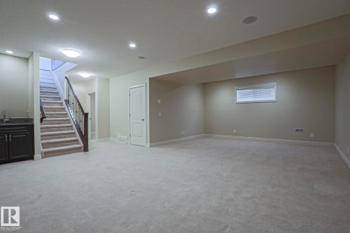 Expansive room with neutral carpet flooring and recessed lighting - 2315 Ashcraft Cape, Edmonton, AB - Indoor