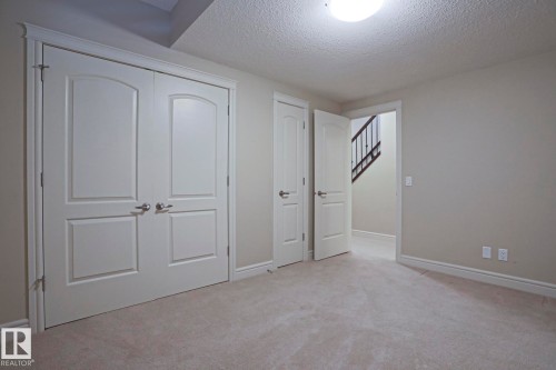 This room features plush grey carpeting, light grey walls, and white trim - 2315 Ashcraft Cape, Edmonton, AB - Indoor Photo Showing Other Room