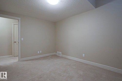 Room featuring neutral wall colors, light-colored carpeting, and a flush mount ceiling light fixture - 2315 Ashcraft Cape, Edmonton, AB - Indoor Photo Showing Other Room