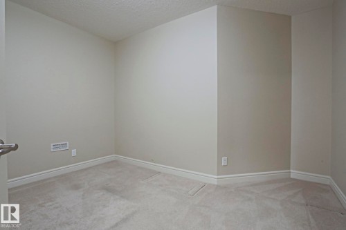 This room features light-colored walls and carpeting, creating a bright and airy atmosphere - 2315 Ashcraft Cape, Edmonton, AB - Indoor Photo Showing Other Room