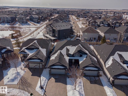 The property features a dark-toned roof and a prominent driveway - 2315 Ashcraft Cape, Edmonton, AB - Outdoor