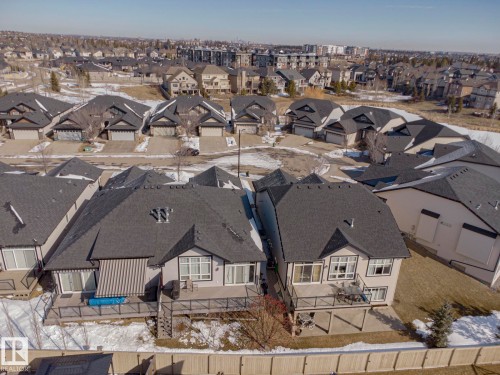 This property features a spacious deck with dark railings, a glass sliding door, and a window with white trim - 2315 Ashcraft Cape, Edmonton, AB - Outdoor With View