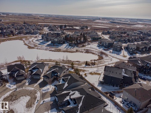 Aerial view of a residential area featuring detached properties with dark roofs, many of which have attached garages - 2315 Ashcraft Cape, Edmonton, AB - Outdoor With View