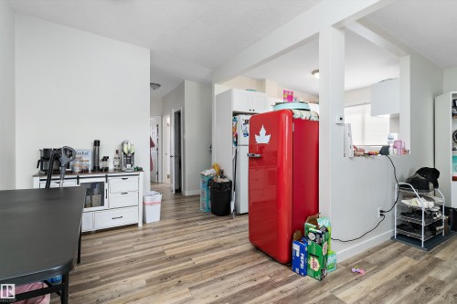 The interior features light-toned walls and wood-style flooring throughout - 6103-6105 97A Avenue, Edmonton, AB - Indoor
