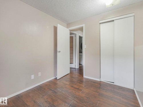 This room features wood-look tile flooring, light-colored walls, and a ceiling fan - 4105 41 Avenue, Edmonton, AB - Indoor Photo Showing Other Room