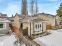 The property features a stucco exterior with dark trim accents and white-framed windows - 4105 41 Avenue, Edmonton, AB  - Outdoor 