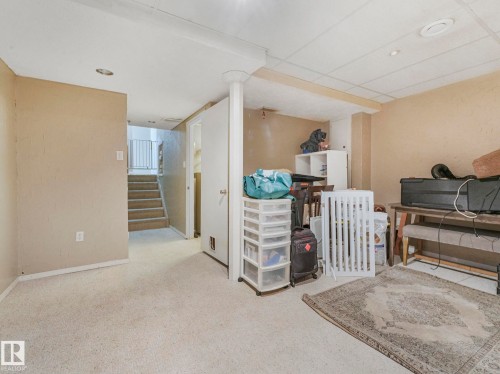 The property includes a basement space with carpet flooring, light beige walls, and recessed lighting - 4105 41 Avenue, Edmonton, AB - Indoor
