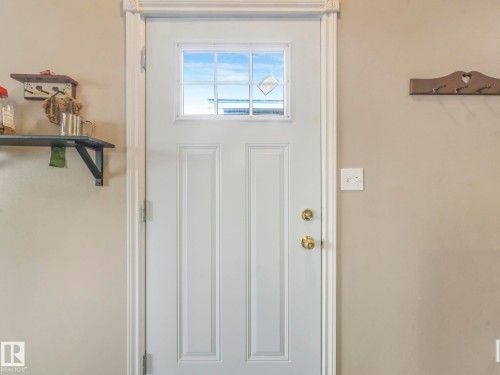 Entryway featuring a white paneled door with a window, gold-toned hardware, and light-colored walls - 4105 41 Avenue, Edmonton, AB - Indoor Photo Showing Other Room