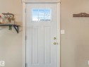 Entryway featuring a white paneled door with a window, gold-toned hardware, and light-colored walls - 4105 41 Avenue, Edmonton, AB  - Indoor Photo Showing Other Room 