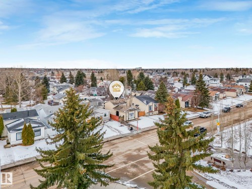 An aerial view showcases the property within a neighborhood featuring diverse architectural styles and mature trees - 4105 41 Avenue, Edmonton, AB - Outdoor With View