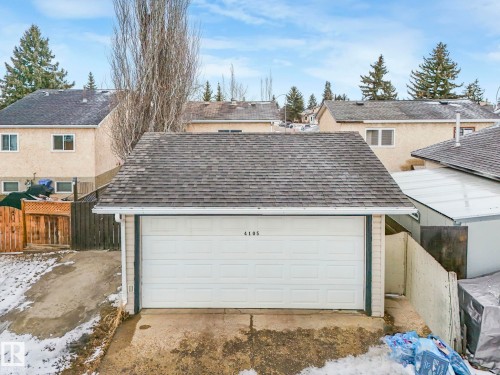 Detached garage with a shingled roof and a white overhead door - 4105 41 Avenue, Edmonton, AB - Outdoor With Exterior