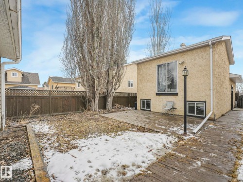 The property features a stucco exterior, a large rear window, and lower level windows - 4105 41 Avenue, Edmonton, AB - Outdoor