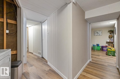 This property features wood-style flooring and light-colored walls - 15926 92 Avenue, Edmonton, AB - Indoor Photo Showing Other Room