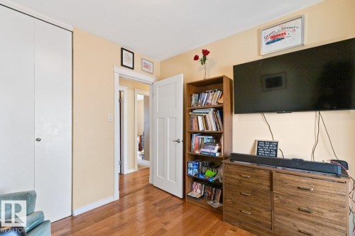 This room features hardwood flooring, light-colored walls, and a white interior door - 15926 92 Avenue, Edmonton, AB - Indoor Photo Showing Other Room