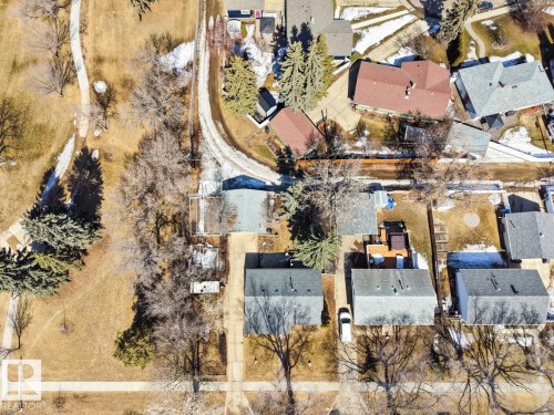 Aerial view of the property and surrounding neighborhood, featuring residential homes with gray and red roofs, paved roads, and areas with trees and grass - 15926 92 Avenue, Edmonton, AB - Outdoor With View
