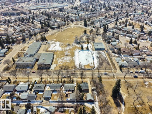 Aerial view showcasing the surrounding neighborhood, featuring residential properties, commercial buildings, and open green spaces - 15926 92 Avenue, Edmonton, AB - Outdoor With View
