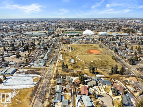 Aerial view showcasing the property's surrounding neighborhood, featuring a residential street, a baseball diamond, and a domed building - 15926 92 Avenue, Edmonton, AB - Outdoor With View