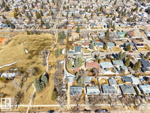 This aerial view showcases the property's advantageous position within a residential neighborhood, featuring established homes and tree-lined streets - 15926 92 Avenue, Edmonton, AB - Outdoor With View