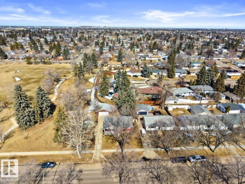 Expansive aerial view showcasing the surrounding residential area with numerous houses and mature trees - 15926 92 Avenue, Edmonton, AB - Outdoor With View