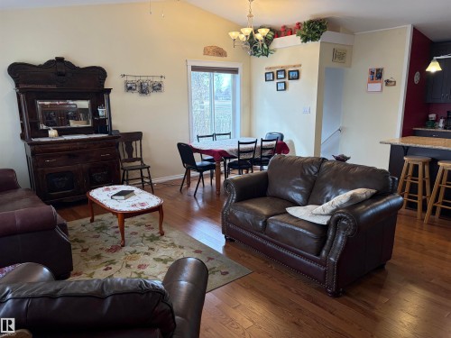 The living area features hardwood floors and a vaulted ceiling - 15926 92 Avenue, Edmonton, AB - Indoor Photo Showing Living Room