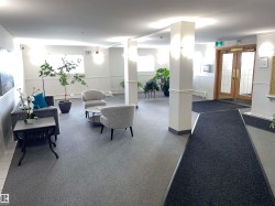 The property features a reception area with carpet flooring, several windows providing natural light, and a double-door entrance - 
