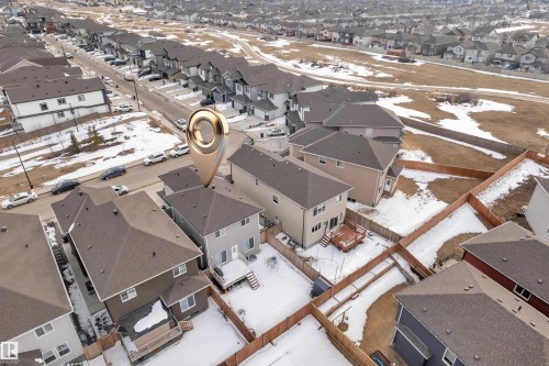 Aerial view of the property and its surrounding neighborhood, featuring residential homes with sloped roofs and backyards - 2630 16A Ave Nw, Edmonton, AB - Outdoor With View