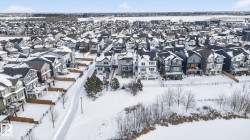 Aerial view of the community, showcasing a mix of modern and traditional home styles with various rooflines and exterior finishes - 
