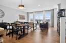 The property features an open-concept living area with hardwood flooring and large sliding glass doors leading to a balcony - 3230 Parker Loop, Edmonton, AB  - Indoor Photo Showing Dining Room 