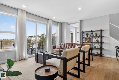 Living area featuring light-colored walls, recessed lighting, and hardwood flooring - 3230 Parker Loop, Edmonton, AB - Indoor Photo Showing Living Room