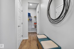 This entryway features hardwood flooring and a built-in storage bench - 