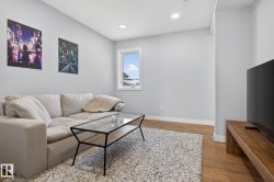 This property features light-colored walls, recessed lighting, and wood flooring - 