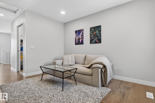 This inviting living area features hardwood flooring, a neutral color palette on the walls, and recessed lighting - 3230 Parker Loop, Edmonton, AB - Indoor