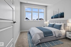 A bright and airy bedroom featuring a large window, plush carpet, and a modern paneled door - 