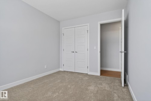 Room featuring light gray walls, white baseboards, and neutral carpet - 3230 Parker Loop, Edmonton, AB - Indoor Photo Showing Other Room