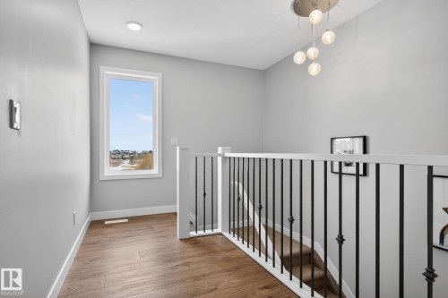 This property features bright, neutral painted walls, hard surface flooring, and a window providing natural light - 3230 Parker Loop, Edmonton, AB - Indoor Photo Showing Other Room