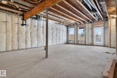 The property features an unfinished space with concrete flooring, exposed ceiling joists, and insulated walls - 3230 Parker Loop, Edmonton, AB - Indoor Photo Showing Basement