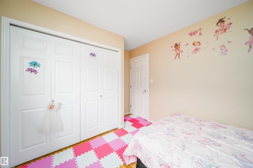 This room features light-toned walls and a white door, complemented by white bi-fold closet doors - 8932 175 Avenue, Edmonton, AB - Indoor Photo Showing Bedroom