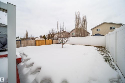 The property features a spacious backyard with a white privacy fence - 8932 175 Avenue, Edmonton, AB - Outdoor
