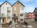 The property features a multi-story exterior with a balcony, a front fence, and a front entry door - 95 1010 Rabbit Hill Road, Edmonton, AB  - Outdoor With Facade 