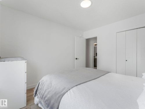 This bright room features light-colored walls, recessed ceiling lighting, and light-toned flooring - 95 1010 Rabbit Hill Road, Edmonton, AB - Indoor Photo Showing Bedroom